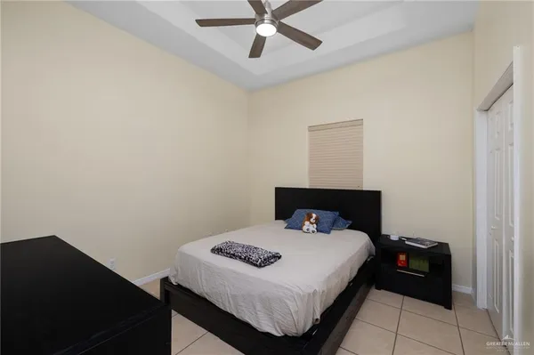 a bedroom with a bed and a ceiling fan