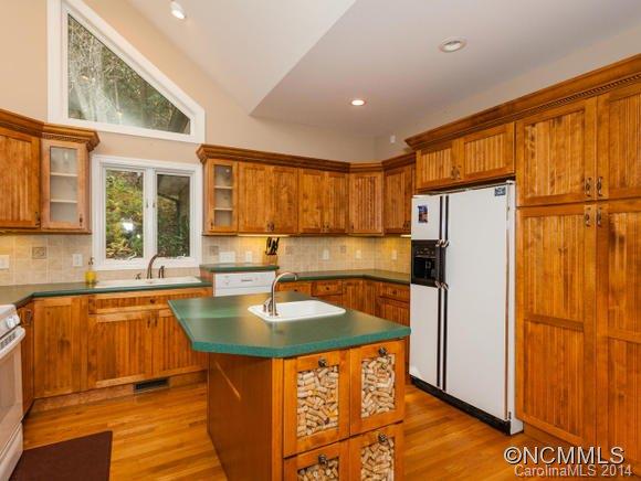 182 Flying Hawk Road Waynesville, NC 28786 - Photo 11 of 24 a kitchen with stainless steel appliances granite countertop a refrigerator a sink and a stove