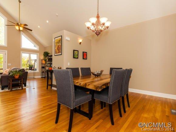 182 Flying Hawk Road Waynesville, NC 28786 - Photo 12 of 24 a view of a dining room with furniture and wooden floor