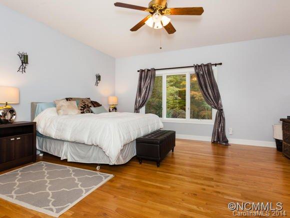182 Flying Hawk Road Waynesville, NC 28786 - Photo 13 of 24 a bedroom with a bed and a large window