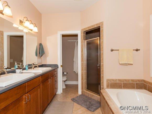 182 Flying Hawk Road Waynesville, NC 28786 - Photo 14 of 24 a bathroom with a sink a toilet and shower