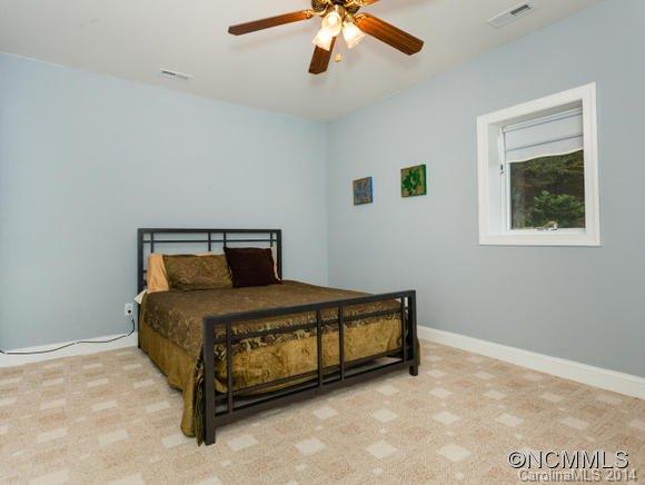 182 Flying Hawk Road Waynesville, NC 28786 - Photo 16 of 24 a bedroom with a bed and window