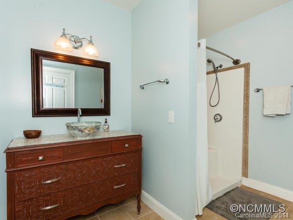 182 Flying Hawk Road Waynesville, NC 28786 - Photo 22 of 24 a bathroom with a sink vanity and mirror