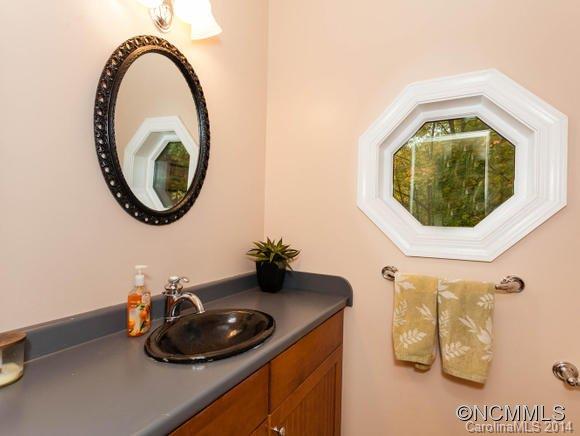 182 Flying Hawk Road Waynesville, NC 28786 - Photo 23 of 24 a bathroom with a sink and a mirror