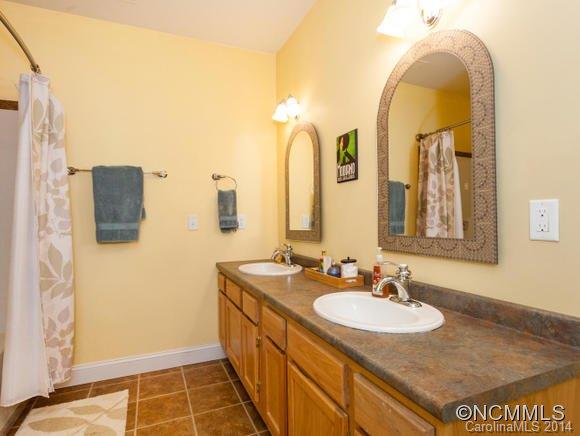182 Flying Hawk Road Waynesville, NC 28786 - Photo 24 of 24 a bathroom with a sink and a mirror