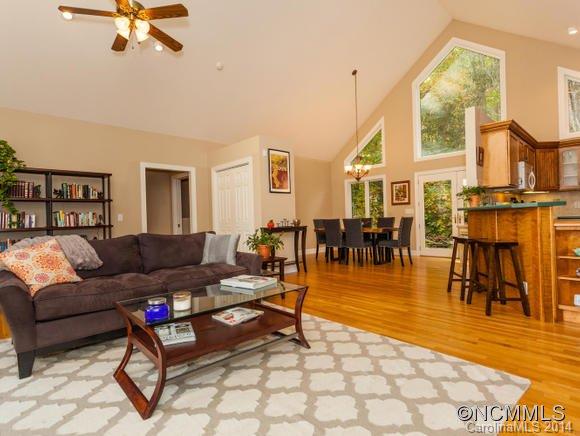 182 Flying Hawk Road Waynesville, NC 28786 - Photo 6 of 24 a living room with furniture a dining table and a large window