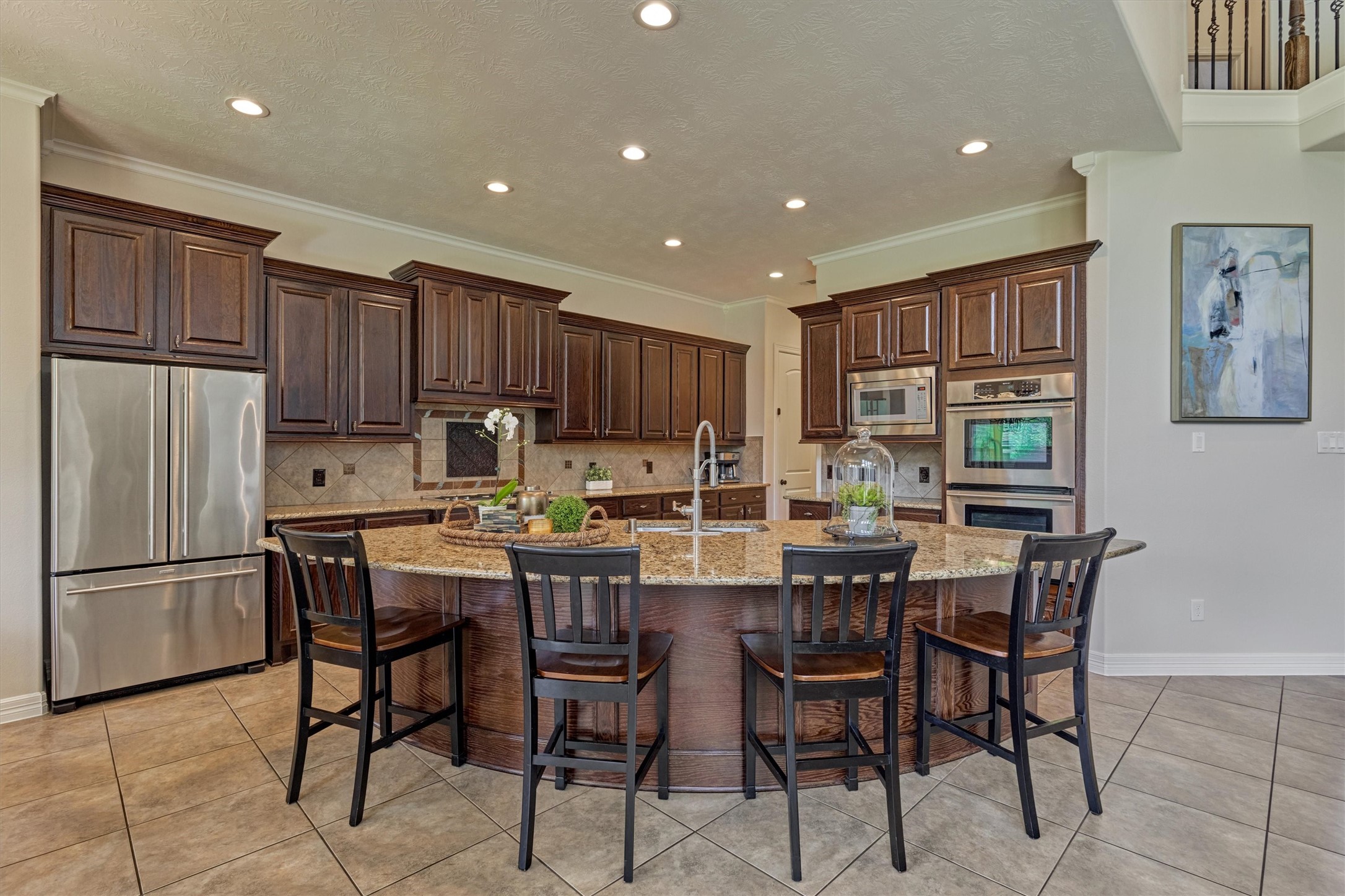 67 South Sage Sparrow Circle Spring, TX 77389 - Photo 21 of 49 a kitchen with stainless steel appliances granite countertop a table chairs refrigerator sink and cabinets