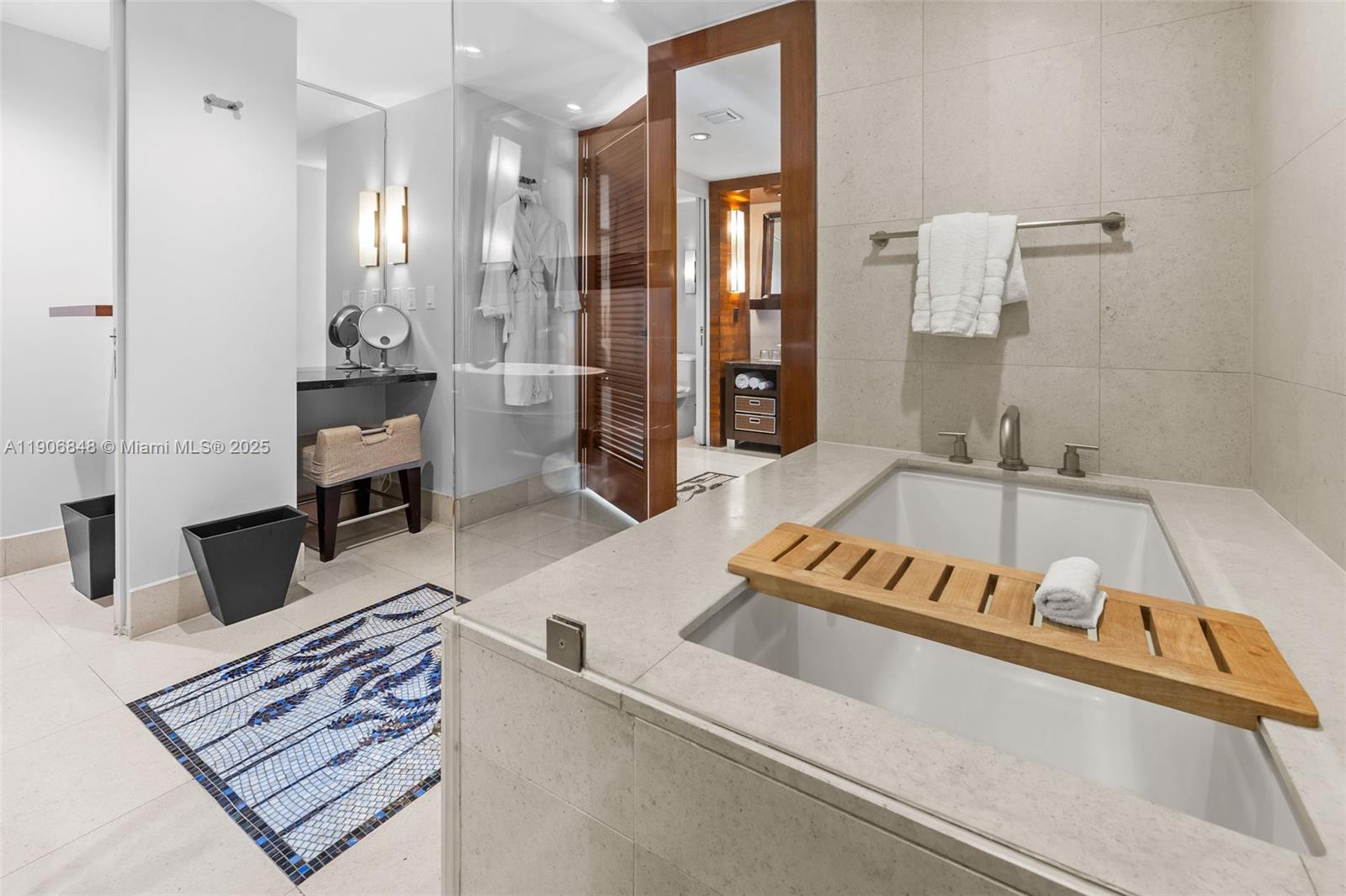 6801 Collins Avenue, Unit 1018 Miami Beach, FL 33141 - Photo 13 of 26 a en suite bathroom with a tub sink and mirror