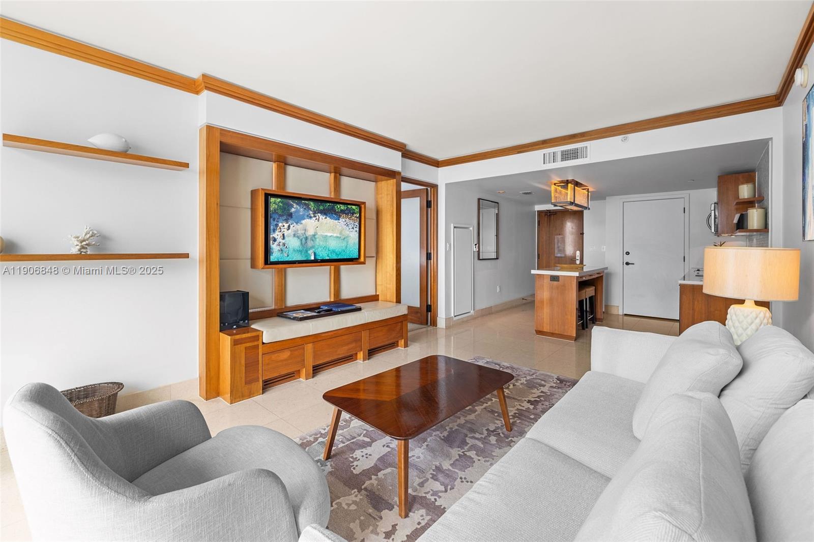 6801 Collins Avenue, Unit 1018 Miami Beach, FL 33141 - Photo 5 of 26 a living room with furniture a rug and a painting on the wall