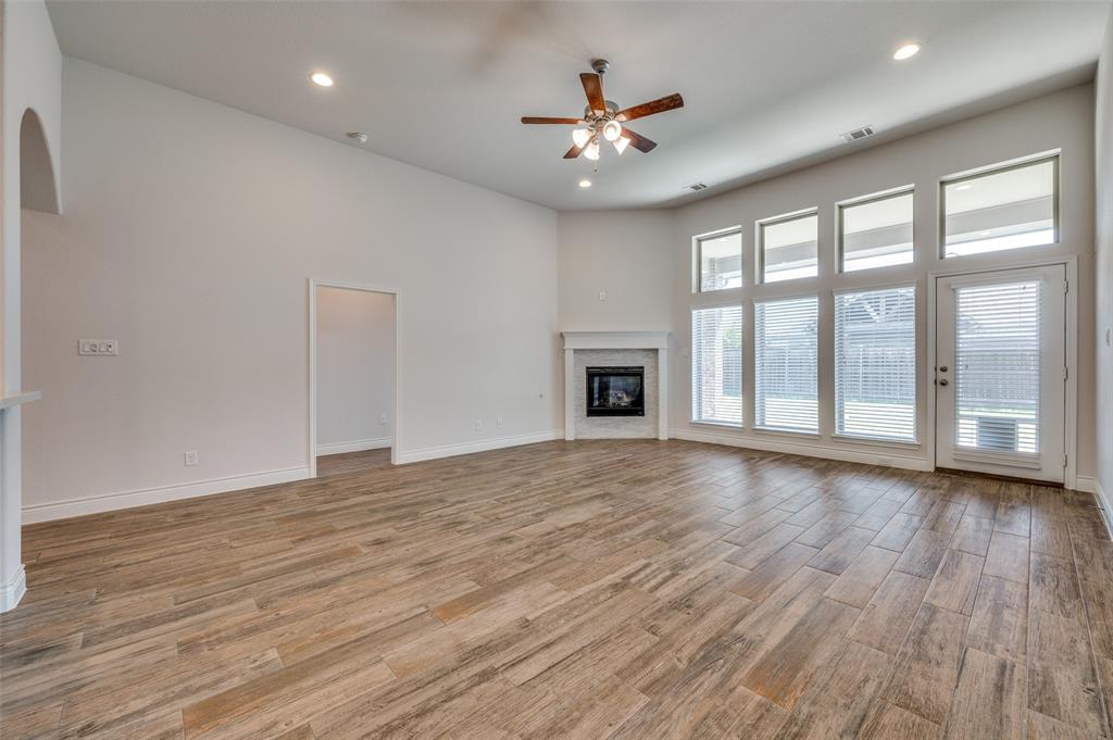 1700 Lithgow Road Celina, TX 75009 - Photo 11 of 40 a view of an empty room with a window and wooden floor
