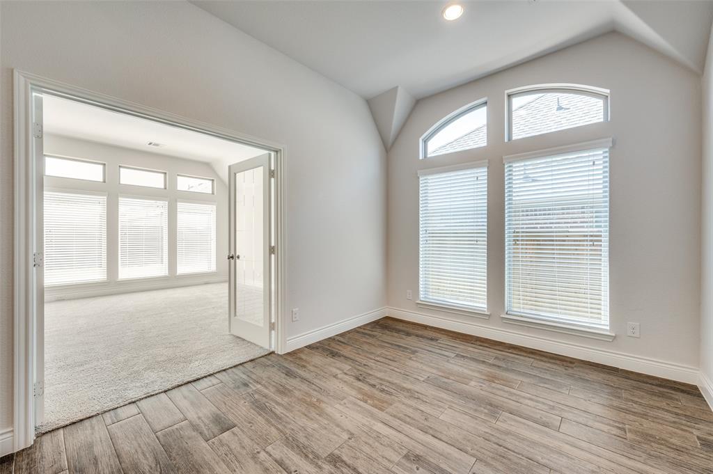 1700 Lithgow Road Celina, TX 75009 - Photo 12 of 40 an empty room with wooden floor and windows