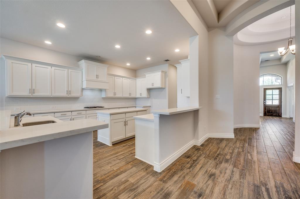 1700 Lithgow Road Celina, TX 75009 - Photo 13 of 40 a kitchen with a hard wood floor stainless steel appliances and cabinets