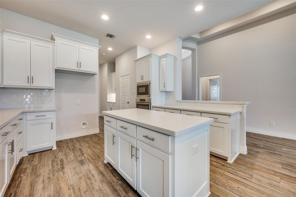 1700 Lithgow Road Celina, TX 75009 - Photo 16 of 40 a kitchen with a stove a sink and a refrigerator