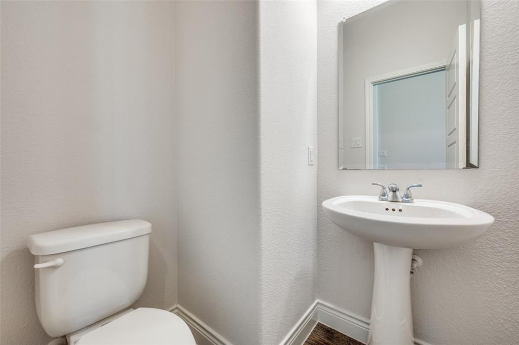 1700 Lithgow Road Celina, TX 75009 - Photo 21 of 40 a bathroom with a toilet sink and mirror