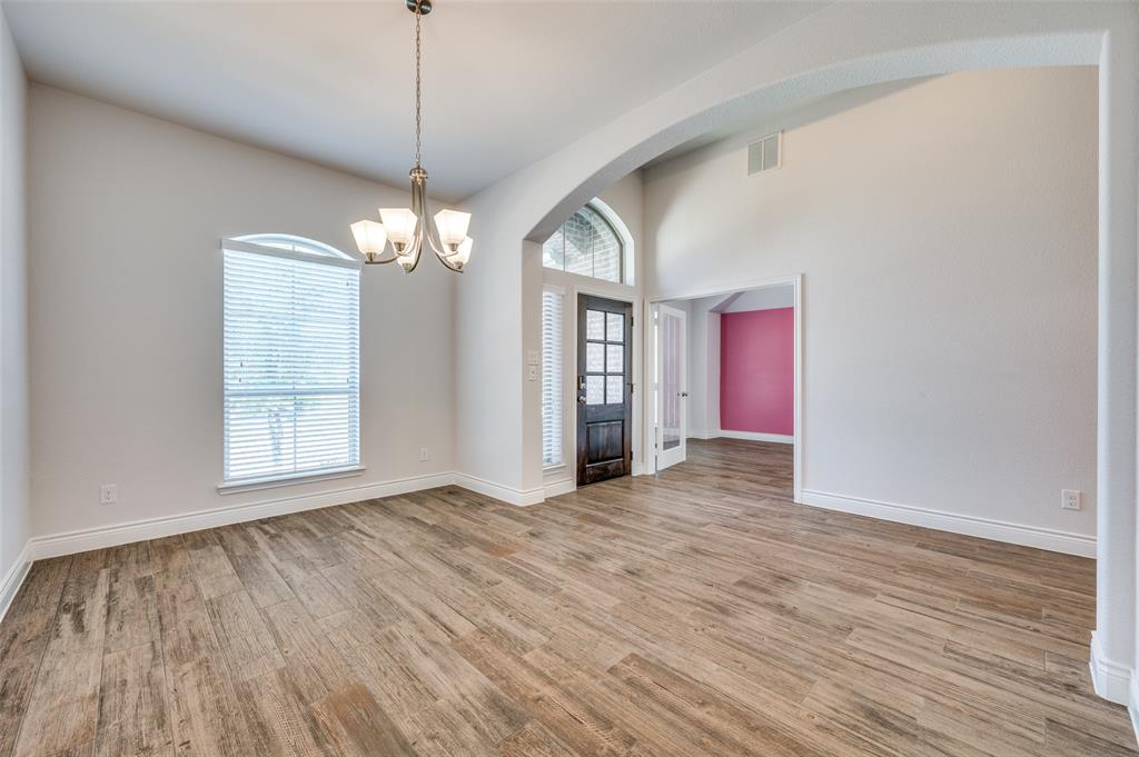 1700 Lithgow Road Celina, TX 75009 - Photo 4 of 40 a view of a room with wooden floor chandelier and windows