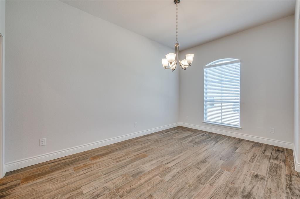 1700 Lithgow Road Celina, TX 75009 - Photo 5 of 40 an empty room with wooden floor and windows