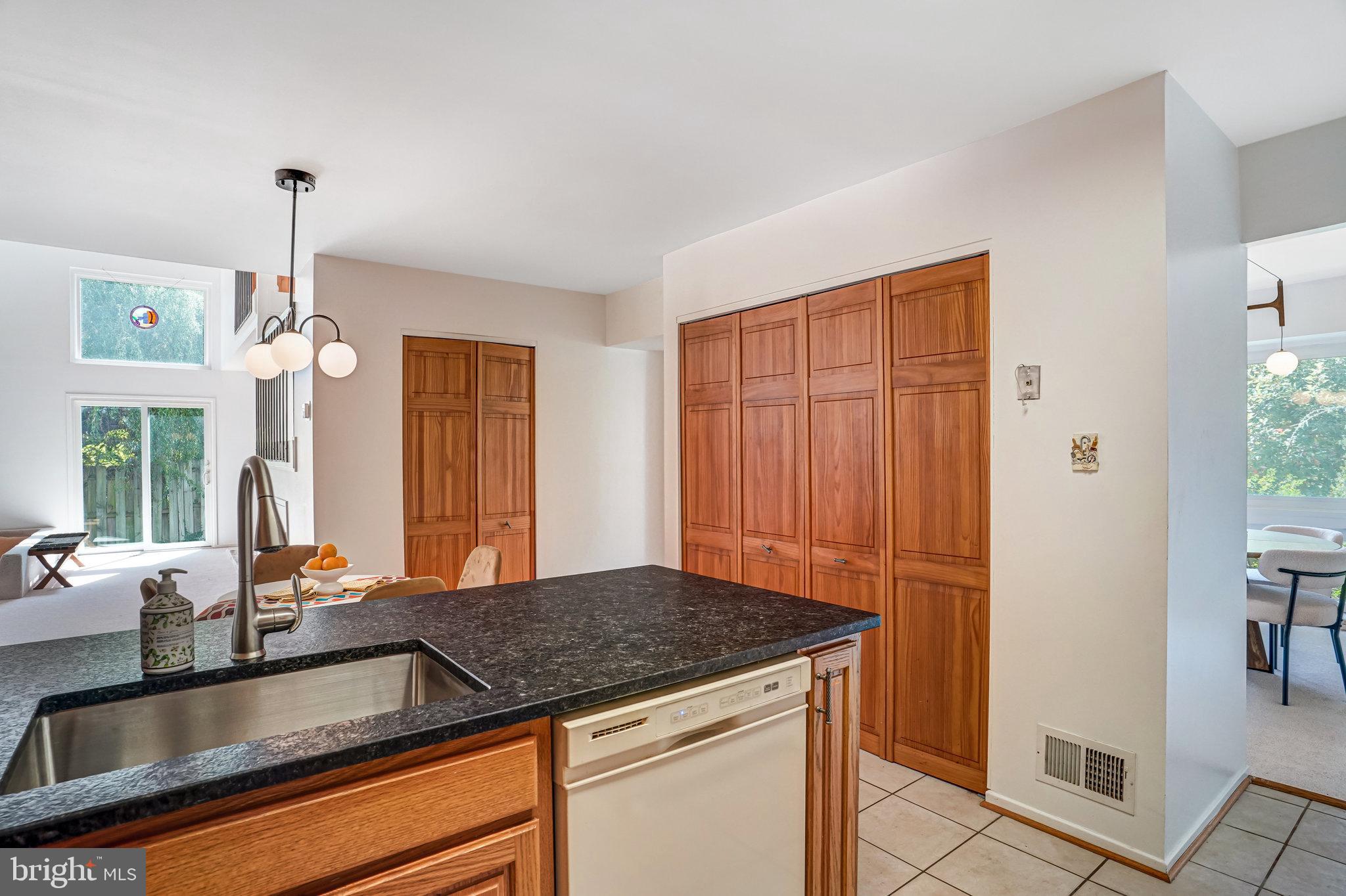 7709 Brandon Way Manassas, VA 20109 - Photo 13 of 40 a kitchen with granite countertop a sink and a counter top space