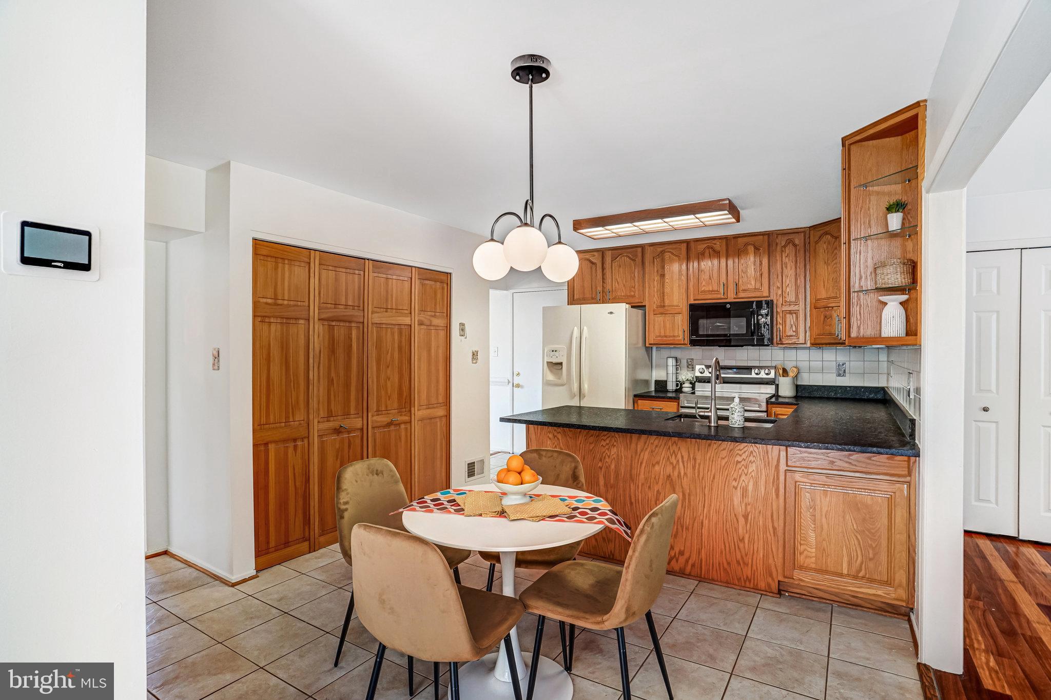 7709 Brandon Way Manassas, VA 20109 - Photo 9 of 40 a kitchen with stainless steel appliances kitchen island granite countertop a sink and cabinets