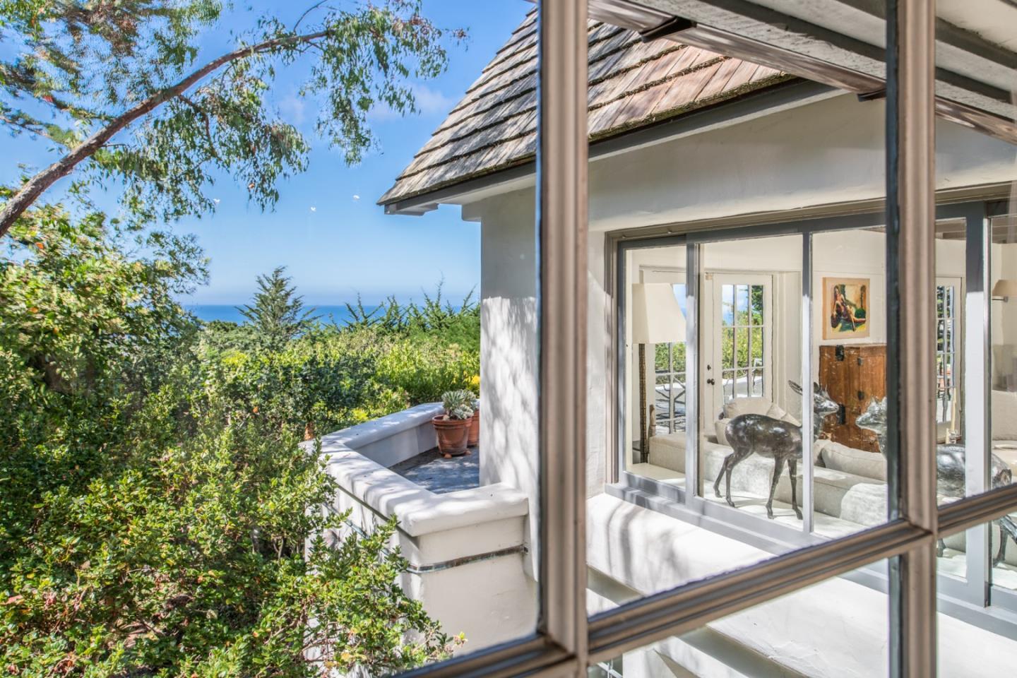 112 Pine Way Carmel Highlands, CA 93923 - Photo 19 of 33 a view of a glass door with a bench in patio