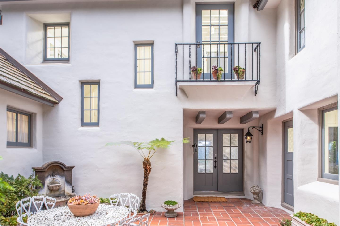 112 Pine Way Carmel Highlands, CA 93923 - Photo 4 of 33 a dining room with furniture potted plants and wooden floor