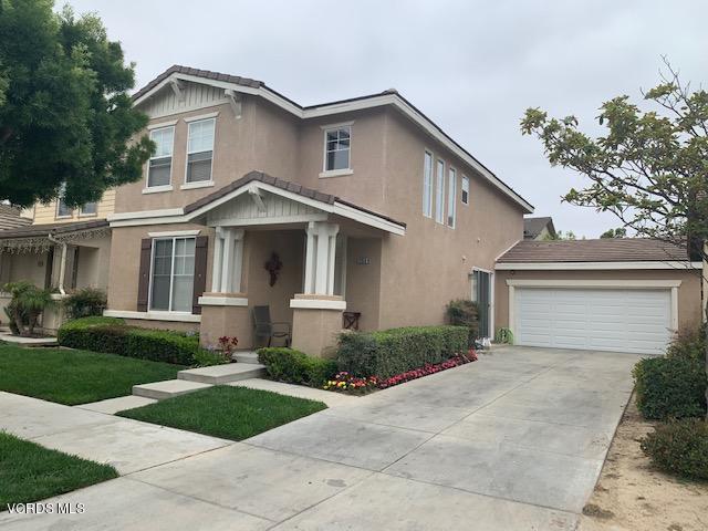 2153 Ribera Drive Oxnard, CA 93030 - Photo 1 of 34 a front view of a house with a yard and garage