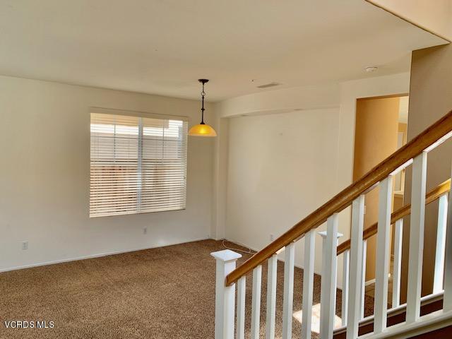 2153 Ribera Drive Oxnard, CA 93030 - Photo 11 of 34 a view of an empty room with wooden floor and fan