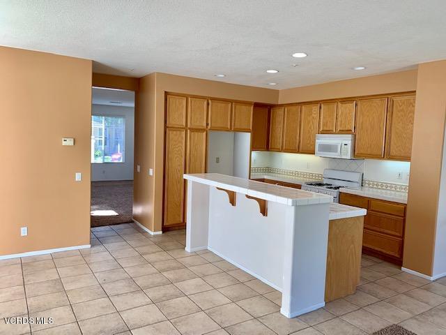 2153 Ribera Drive Oxnard, CA 93030 - Photo 3 of 34 a kitchen with granite countertop a sink and a stove top oven
