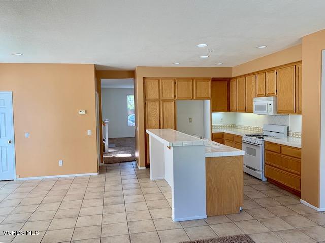 2153 Ribera Drive Oxnard, CA 93030 - Photo 21 of 34 a kitchen with cabinets and wooden floor