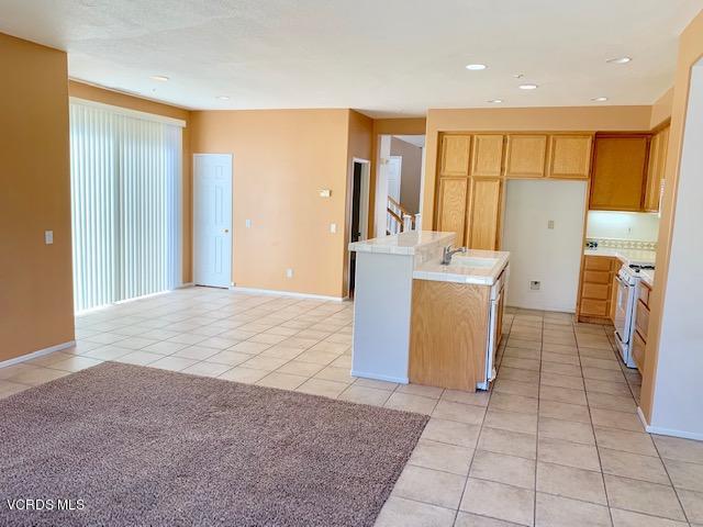 2153 Ribera Drive Oxnard, CA 93030 - Photo 8 of 34 a hall with stainless steel appliances granite countertop a granite counter tops and a view of living room