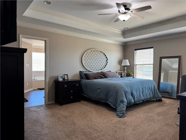 a bedroom with a bed mirror and a window