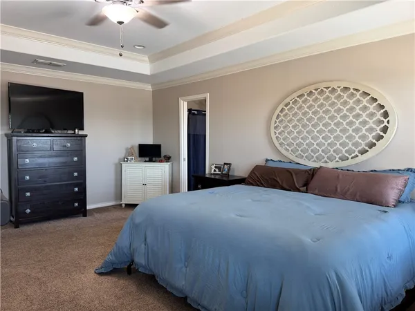 a bedroom with a bed and a television