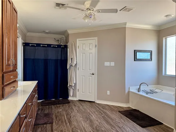a view of a bathroom with sink mirror and bathtub