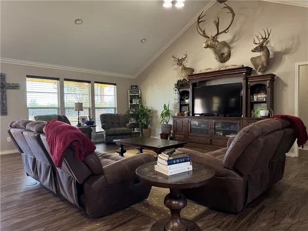 a living room with furniture a flat screen tv and a window