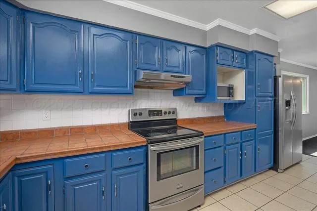 a kitchen with wooden cabinets and a stove top oven