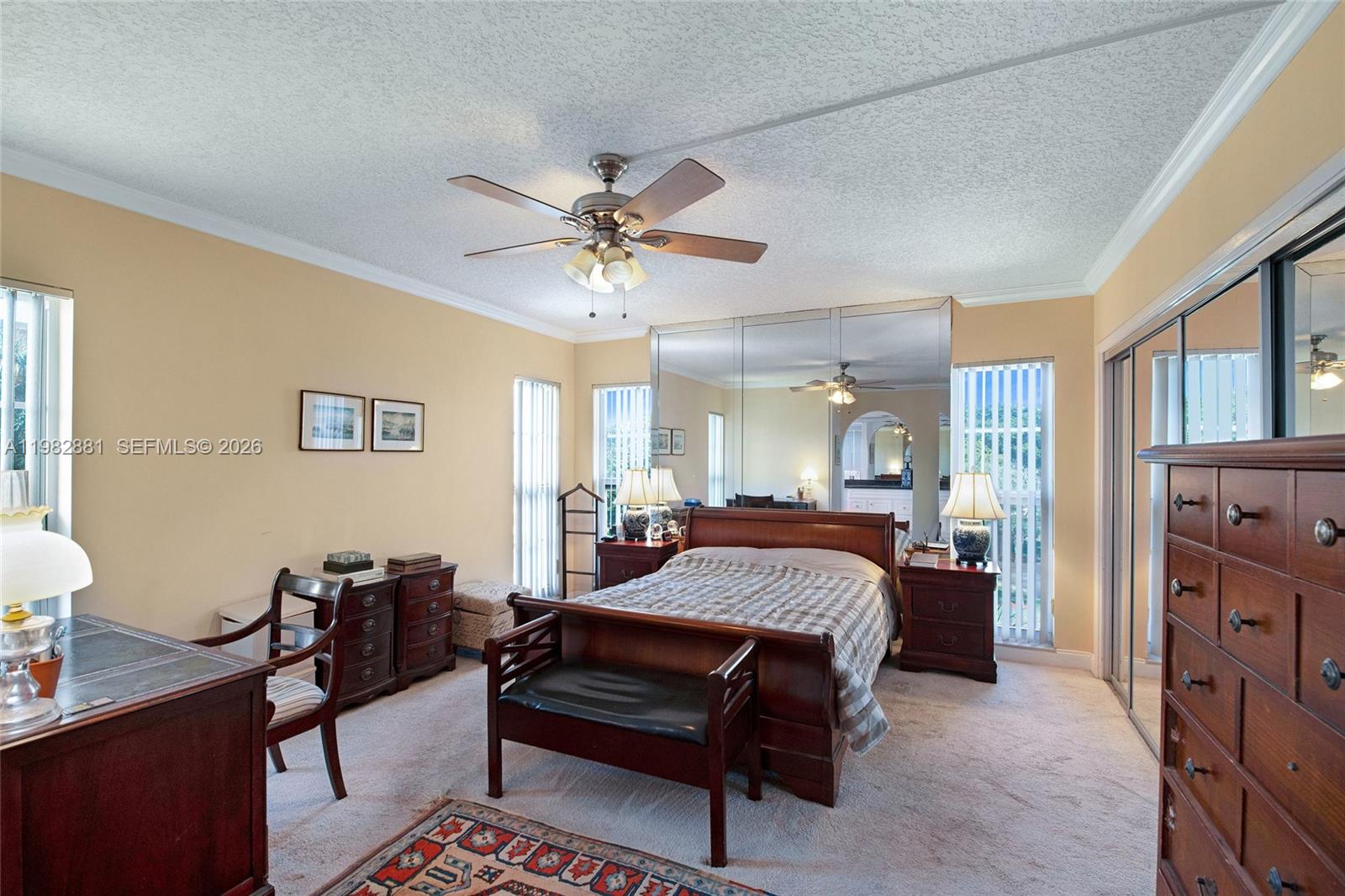 3050 Northeast 48th Court, Unit 401 Lighthouse Point, FL 33064 - Photo 16 of 35 a bedroom with a bed and a chandelier