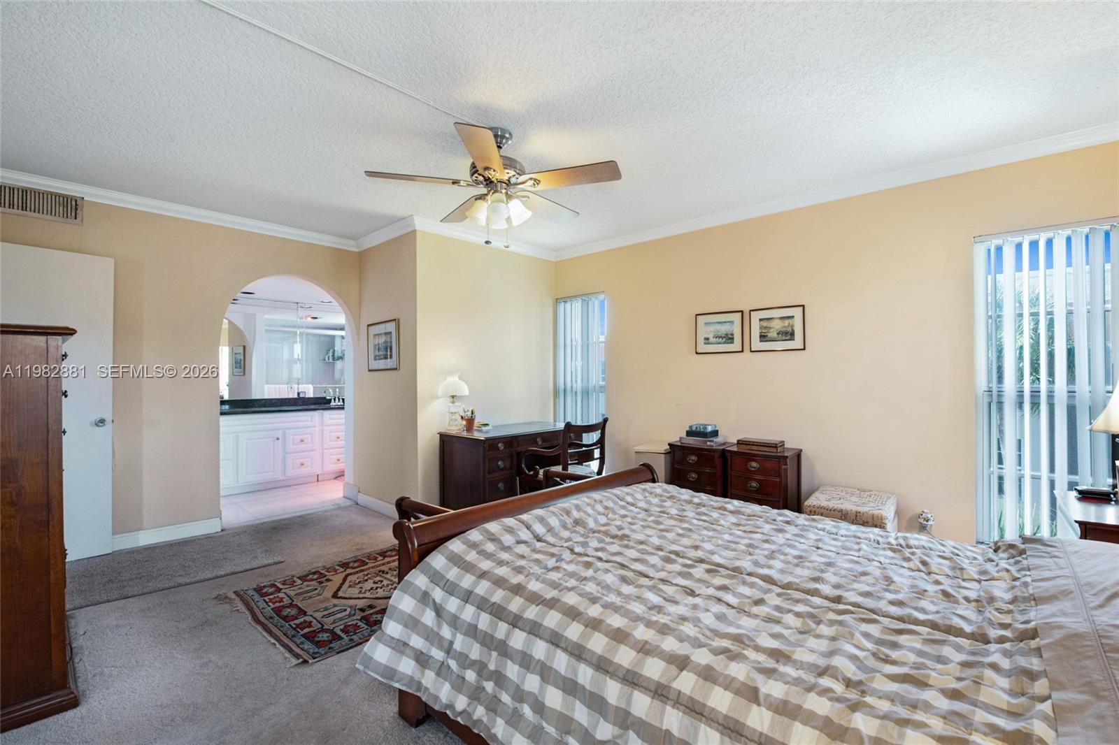 3050 Northeast 48th Court, Unit 401 Lighthouse Point, FL 33064 - Photo 17 of 35 a bedroom with a bed and a chandelier