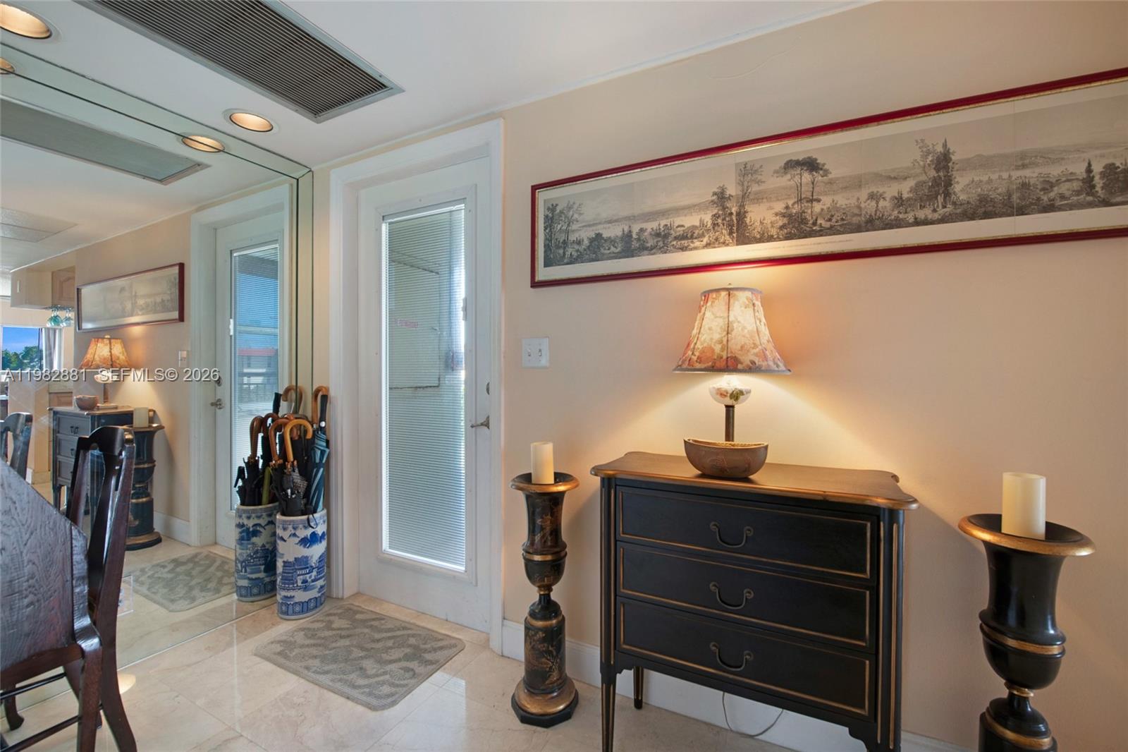 3050 Northeast 48th Court, Unit 401 Lighthouse Point, FL 33064 - Photo 21 of 35 a room with a mirror and furniture