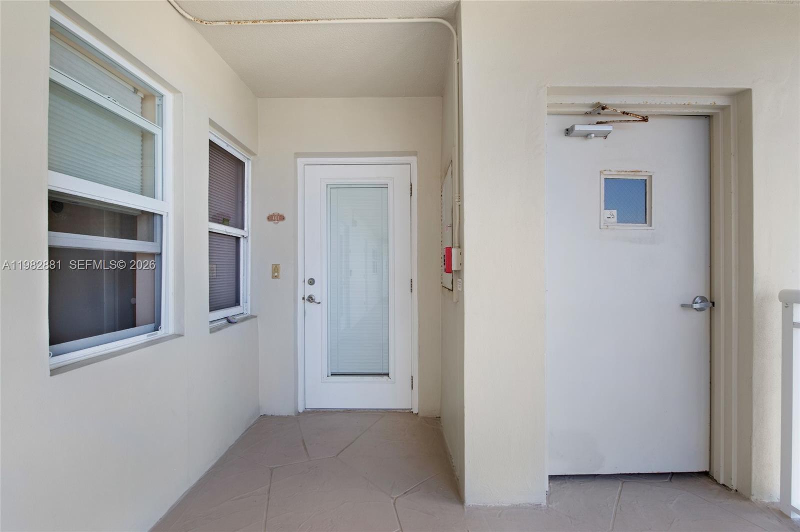 3050 Northeast 48th Court, Unit 401 Lighthouse Point, FL 33064 - Photo 28 of 35 a view of a hallway with wooden shelves