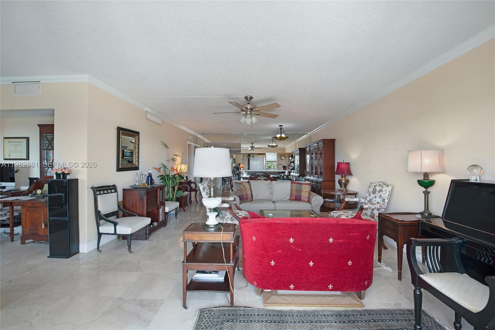 3050 Northeast 48th Court, Unit 401 Lighthouse Point, FL 33064 - Photo 7 of 35 a living room with furniture and a chandelier