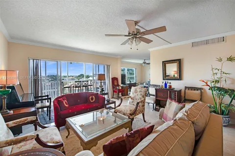 a living room with furniture ceiling fan and a rug