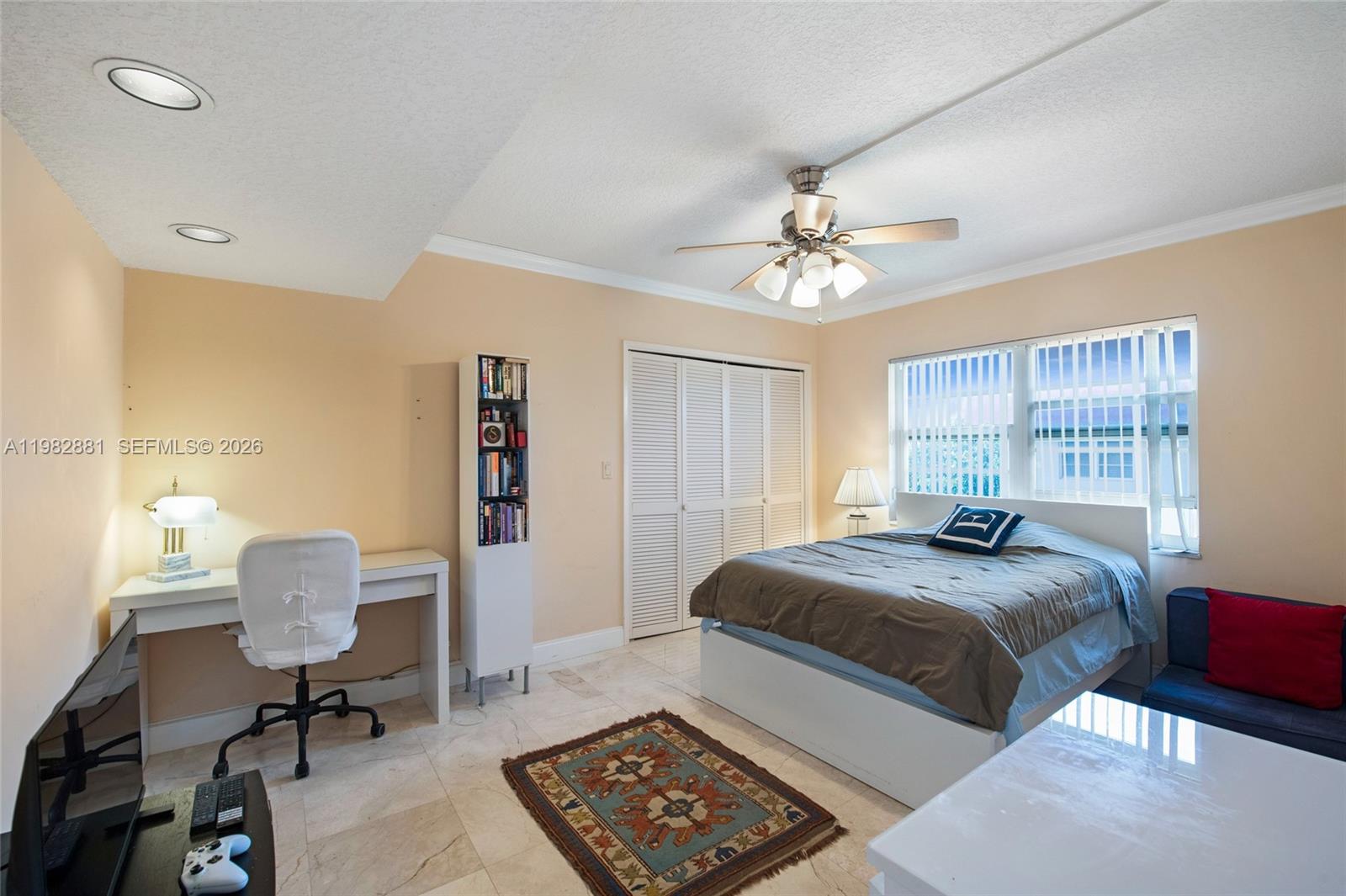 3050 Northeast 48th Court, Unit 401 Lighthouse Point, FL 33064 - Photo 9 of 35 a bedroom with a bed and a chandelier