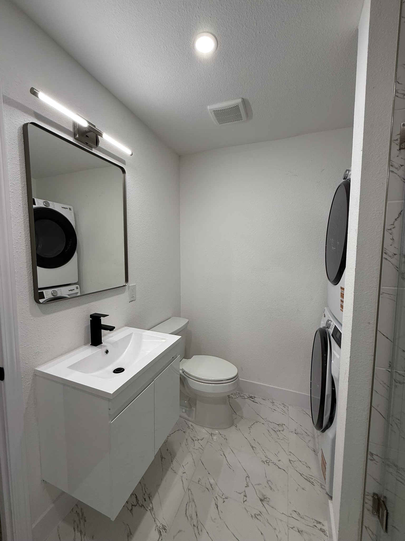 705 Stanford Street, Unit A Houston, TX 77019 - Photo 11 of 16 a bathroom with a sink a toilet and a mirror