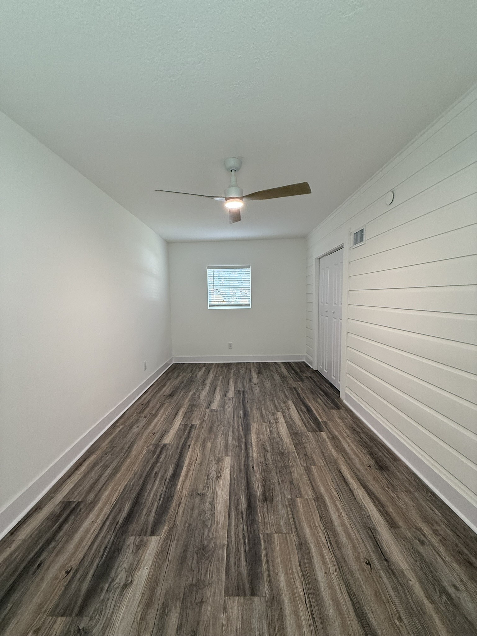 705 Stanford Street, Unit A Houston, TX 77019 - Photo 13 of 16 a view of a room with wooden floor and white walls