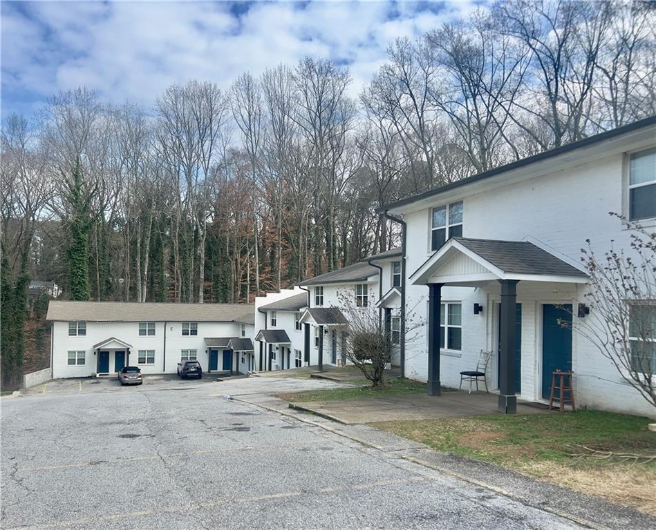 a view of a house with large trees and a barn