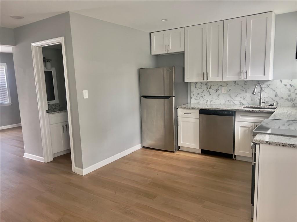 3669 Martin Luther King Junior Drive Southwest Atlanta, GA 30331 - Photo 7 of 24 a kitchen with a refrigerator sink and cabinets