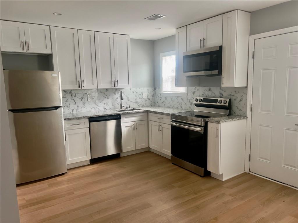 3669 Martin Luther King Junior Drive Southwest Atlanta, GA 30331 - Photo 9 of 24 a kitchen with a sink appliances and cabinets