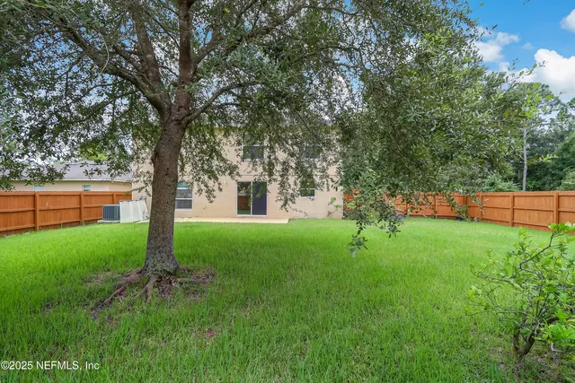 a view of a tree in front of a house