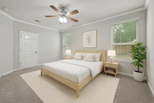 a bedroom with a large bed and a chandelier