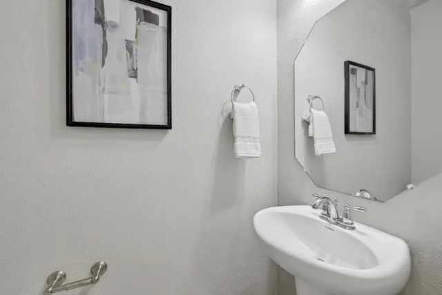 a bathroom with a sink and mirror