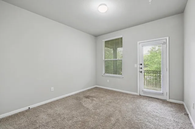 a bedroom with a large bed potted plant and a window